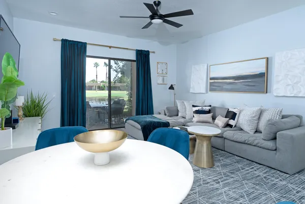 a living room with furniture and a potted plant