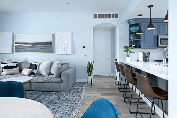 a living room with furniture and a wooden floor