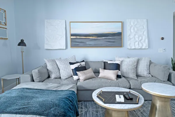 a living room with furniture and a mirror