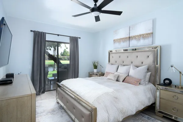 a bedroom with a balcony a bed and a chandelier