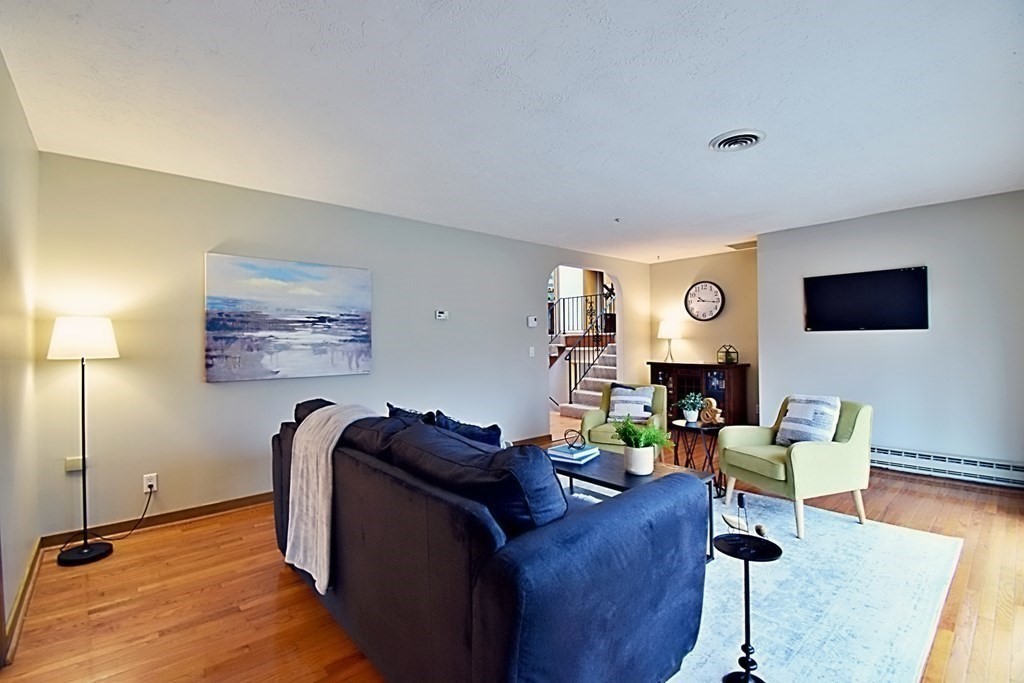 8 McCarthy Circle Framingham, MA 01702 - Photo 13 of 42 a living room with furniture and a flat screen tv