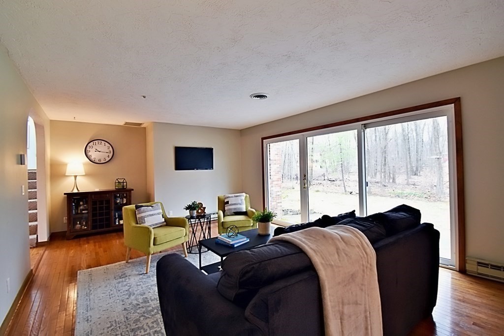 8 McCarthy Circle Framingham, MA 01702 - Photo 14 of 42 a living room with furniture and a flat screen tv