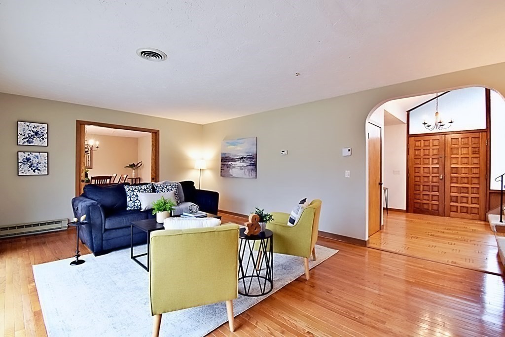 8 McCarthy Circle Framingham, MA 01702 - Photo 15 of 42 a living room with furniture a large window and wooden floor