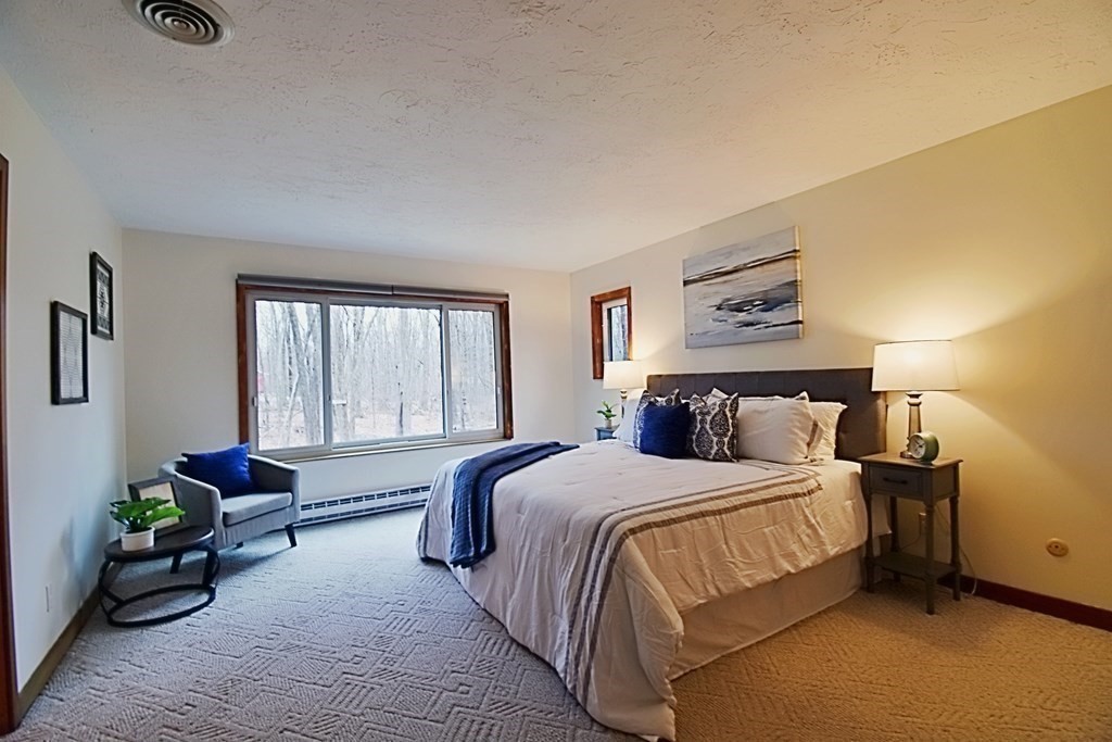 8 McCarthy Circle Framingham, MA 01702 - Photo 17 of 42 a bedroom with a bed and wooden floor
