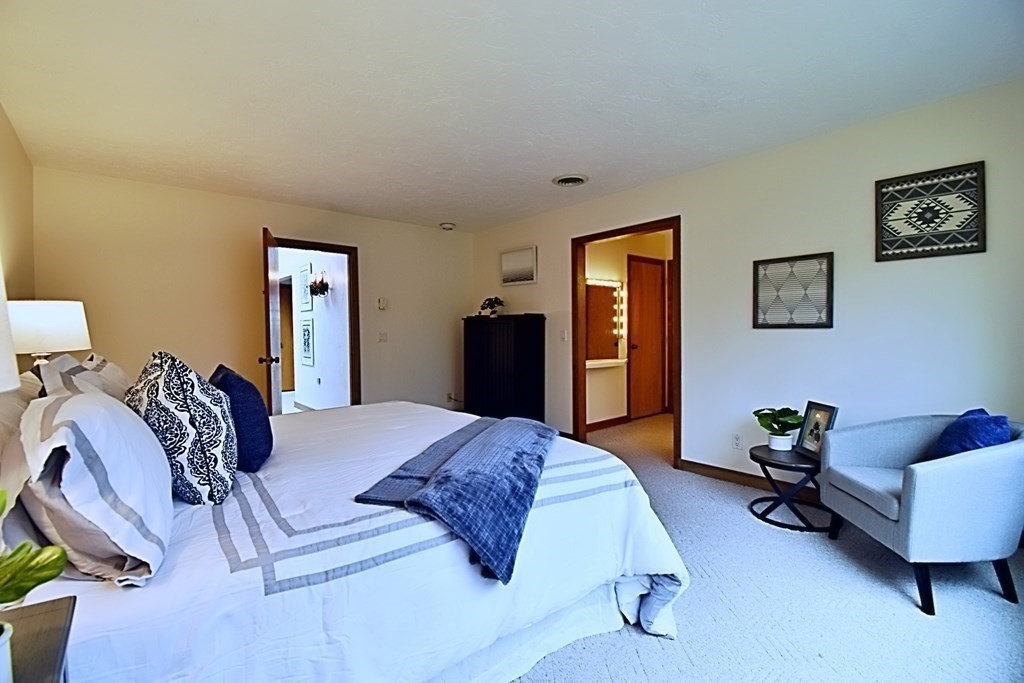 8 McCarthy Circle Framingham, MA 01702 - Photo 18 of 42 a spacious bedroom with a bed and a couch