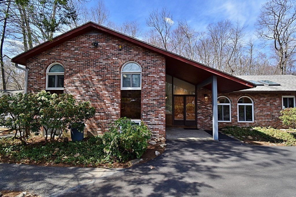 8 McCarthy Circle Framingham, MA 01702 - Photo 2 of 42 a front view of a house with a garden