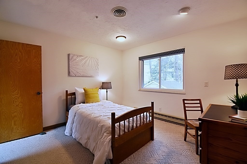 8 McCarthy Circle Framingham, MA 01702 - Photo 22 of 42 a bedroom with a bed and a desk