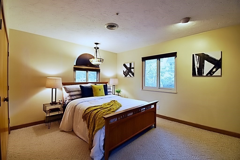 8 McCarthy Circle Framingham, MA 01702 - Photo 23 of 42 a bed room with a bed and a painting on the wall