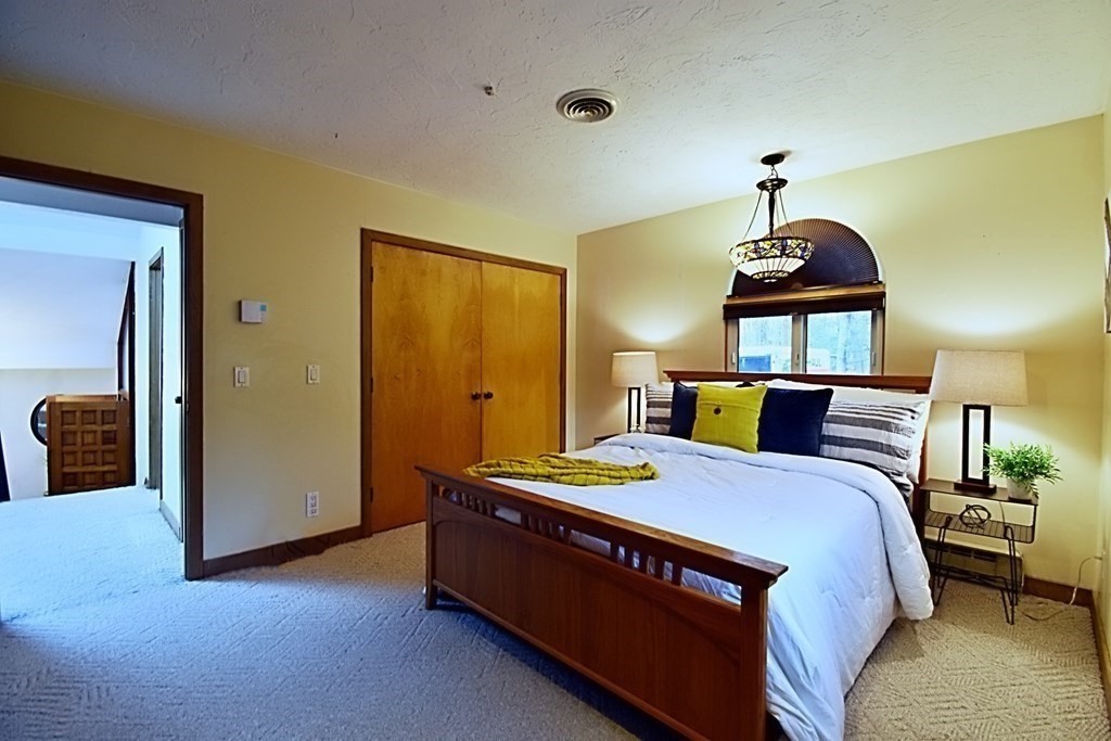 8 McCarthy Circle Framingham, MA 01702 - Photo 24 of 42 a bed room with a bed and a lamp