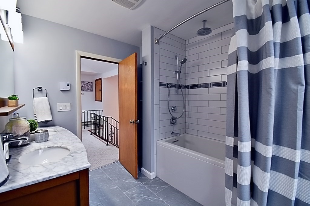 8 McCarthy Circle Framingham, MA 01702 - Photo 26 of 42 a bathroom with a granite countertop sink a mirror and shower