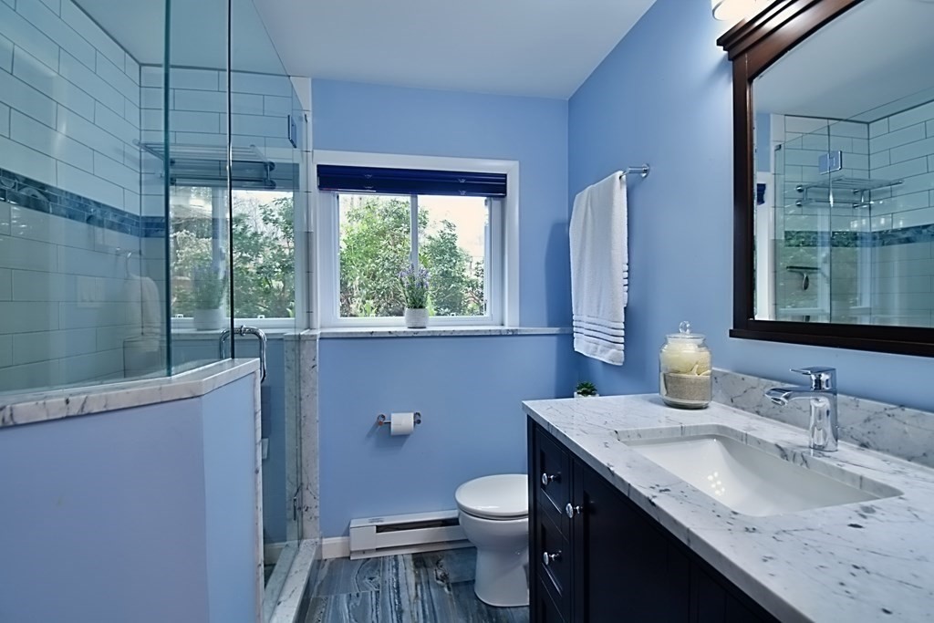 8 McCarthy Circle Framingham, MA 01702 - Photo 30 of 42 a bathroom with a granite countertop sink toilet and mirror