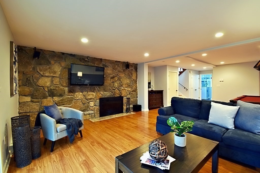 8 McCarthy Circle Framingham, MA 01702 - Photo 35 of 42 a living room with fireplace furniture and a flat screen tv