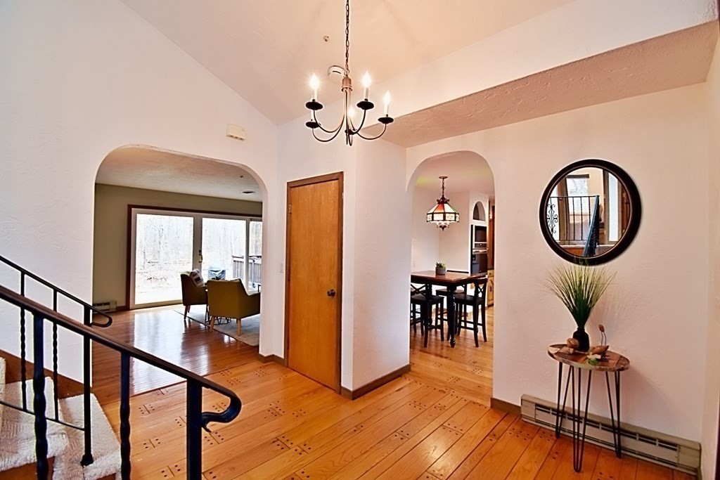 8 McCarthy Circle Framingham, MA 01702 - Photo 6 of 42 a view of a livingroom with furniture entryway wooden floor and a chandelier