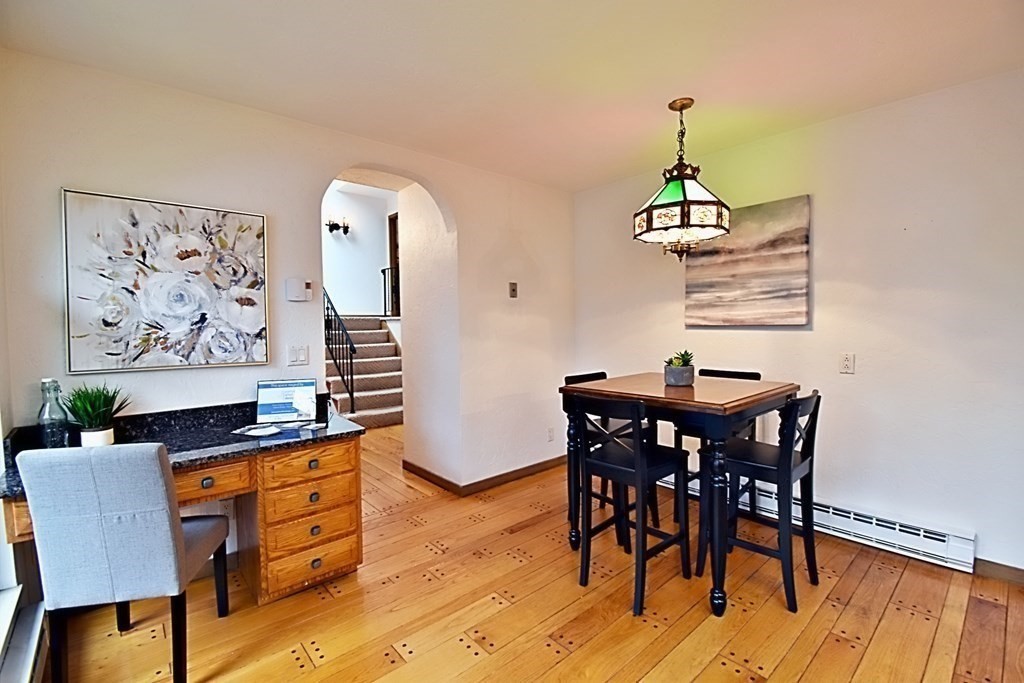8 McCarthy Circle Framingham, MA 01702 - Photo 7 of 42 a view of a dining room with furniture wooden floor and a chandelier
