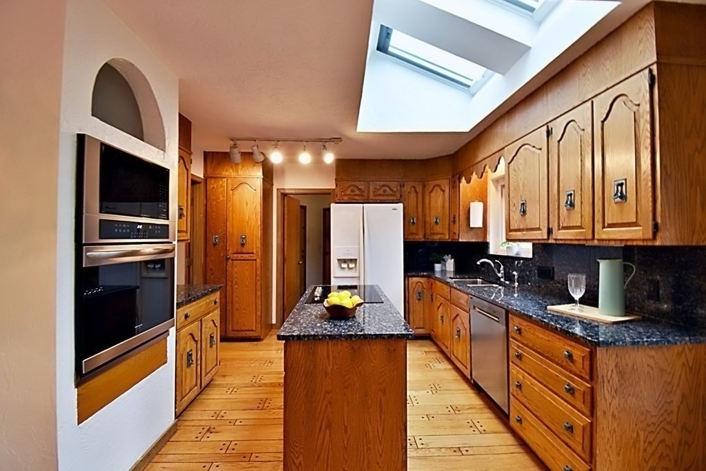 8 McCarthy Circle Framingham, MA 01702 - Photo 9 of 42 a large kitchen with stainless steel appliances granite countertop a refrigerator and a stove
