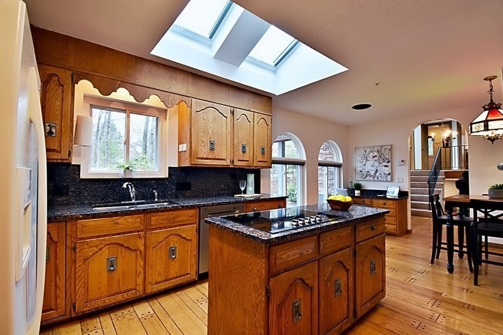8 McCarthy Circle Framingham, MA 01702 - Photo 10 of 42 a kitchen with stainless steel appliances granite countertop a stove a sink dishwasher and cabinets with wooden floor