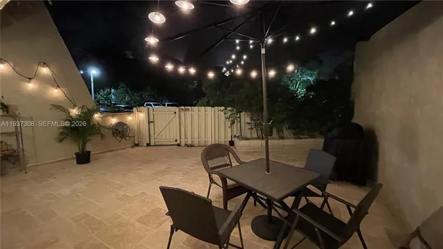 a view of a chairs and table in patio