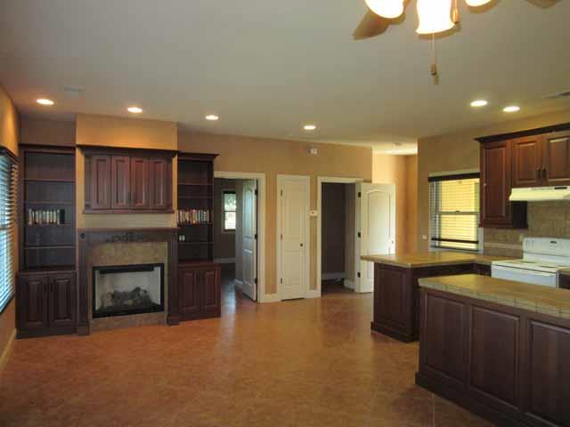 16648-34 Alpine Road Lodi, CA 95240 - Photo 15 of 29 a open kitchen with a refrigerator a sink dishwasher and a fireplace with wooden floor