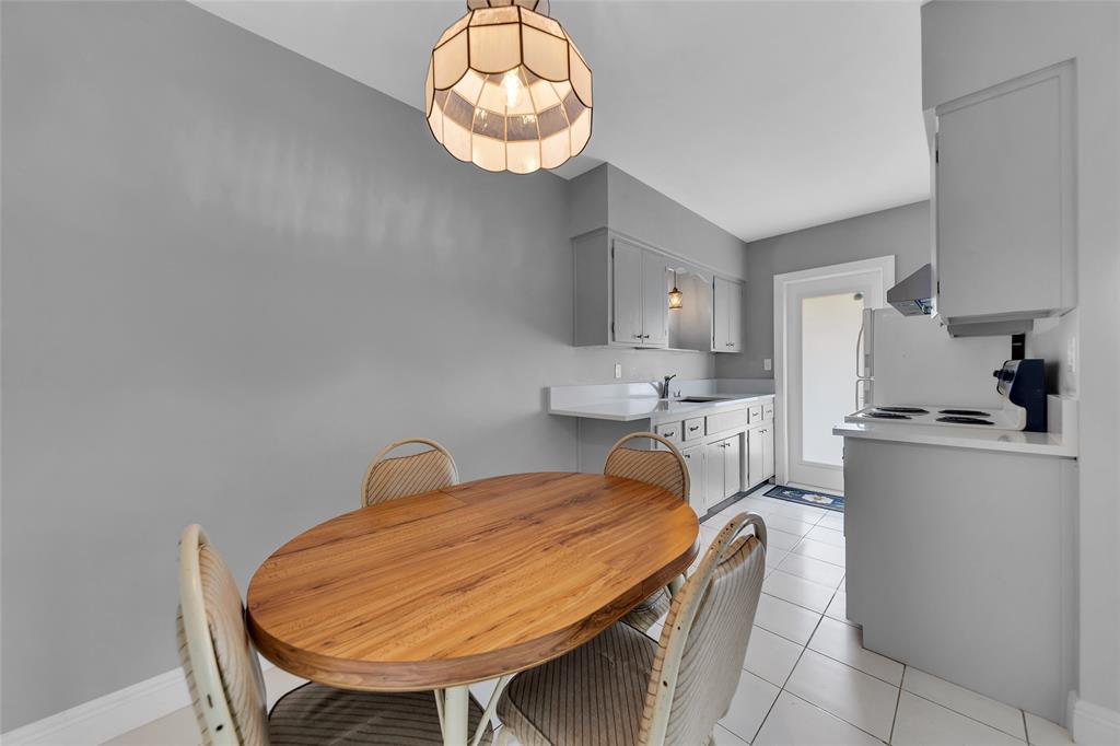 11 Southwest 4th Avenue, Unit 10 Boca Raton, FL 33432 - Photo 11 of 32 a room with a table chairs and wooden floor