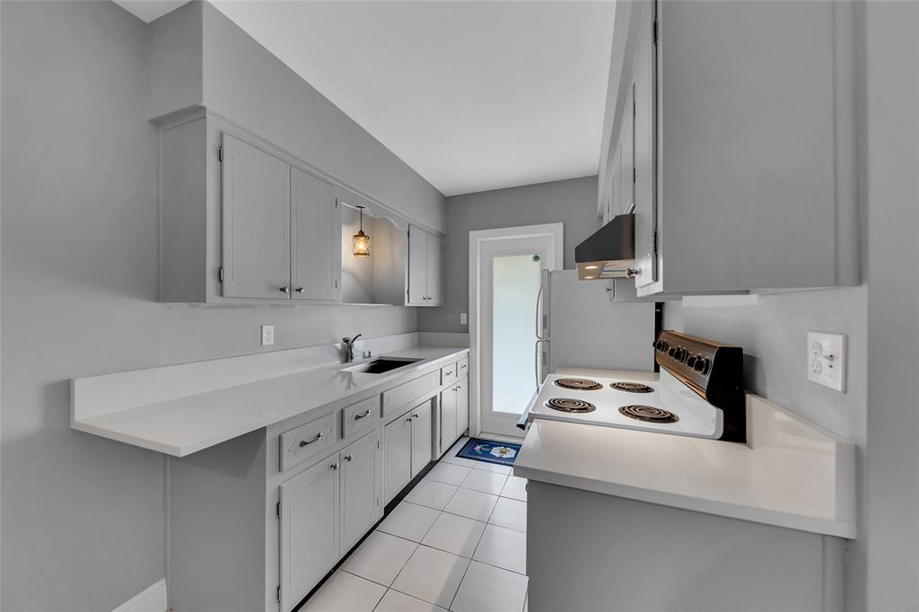 11 Southwest 4th Avenue, Unit 10 Boca Raton, FL 33432 - Photo 13 of 32 a kitchen with cabinets appliances a sink and a counter top space