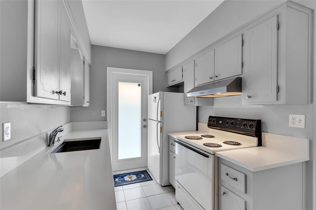 11 Southwest 4th Avenue, Unit 10 Boca Raton, FL 33432 - Photo 15 of 32 a kitchen with a sink a stove and refrigerator