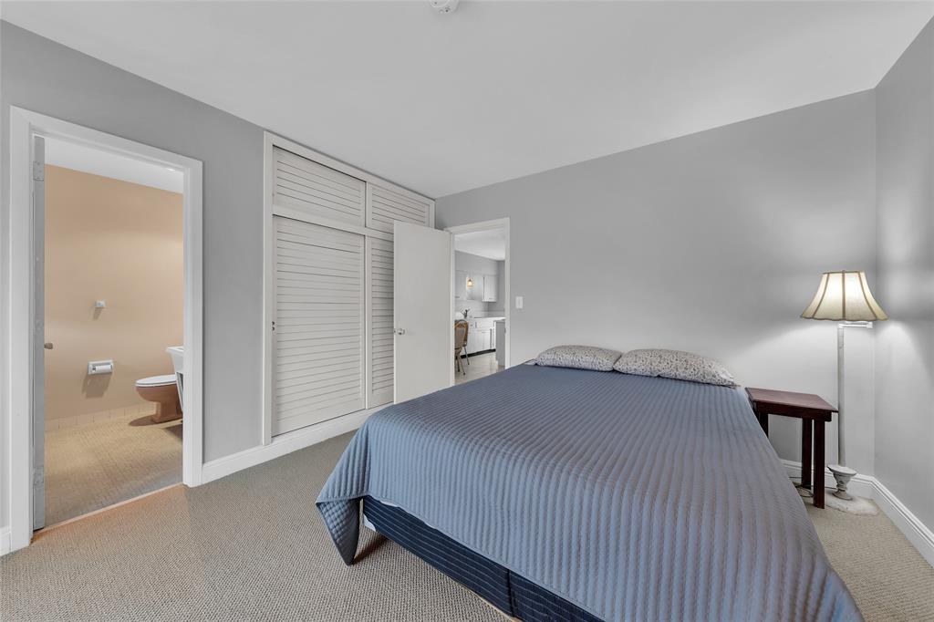 11 Southwest 4th Avenue, Unit 10 Boca Raton, FL 33432 - Photo 20 of 32 a bedroom with a bed and a lamp