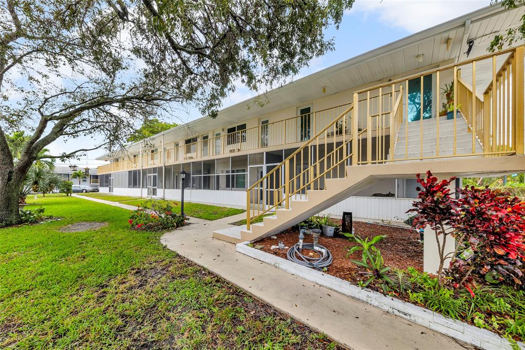 11 Southwest 4th Avenue, Unit 10 Boca Raton, FL 33432 - Photo 28 of 32 front view of a house with a yard