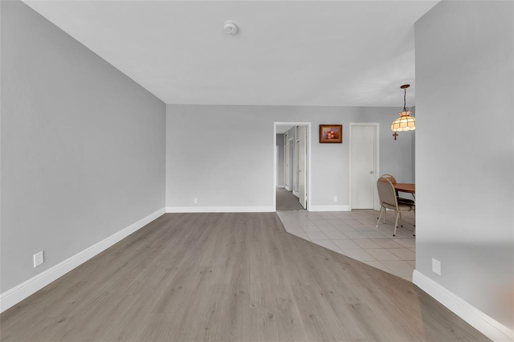 11 Southwest 4th Avenue, Unit 10 Boca Raton, FL 33432 - Photo 6 of 32 a view of empty room with wooden floor and fan