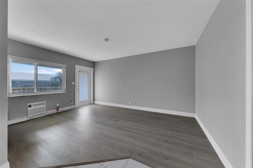 11 Southwest 4th Avenue, Unit 10 Boca Raton, FL 33432 - Photo 8 of 32 an empty room with wooden floor and windows