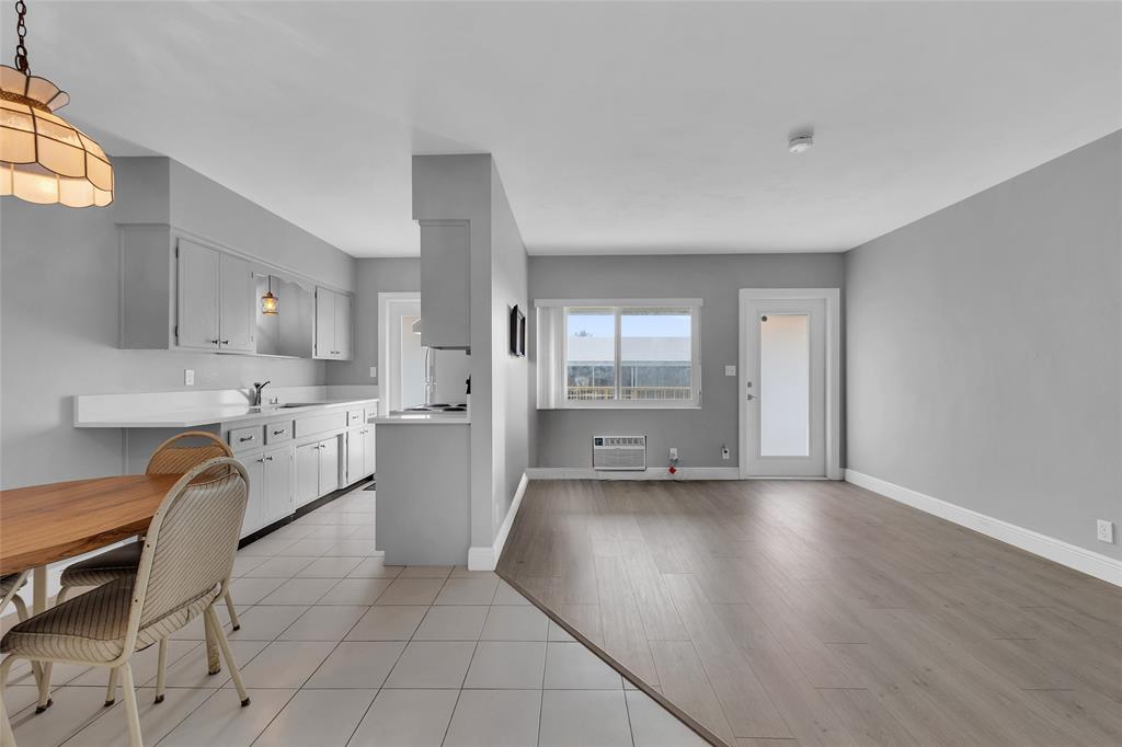 11 Southwest 4th Avenue, Unit 10 Boca Raton, FL 33432 - Photo 9 of 32 a kitchen with granite countertop a stove a sink and a refrigerator