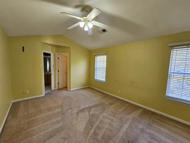 a view of a room with a ceiling fan