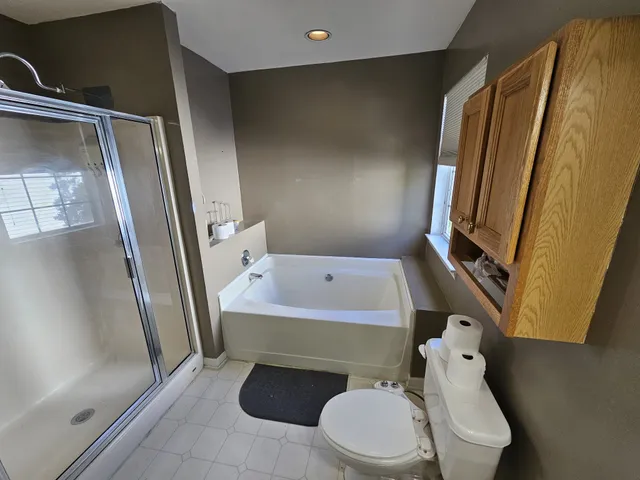 a bathroom with a sink and mirror with bathtub