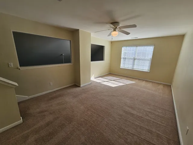 a view of a livingroom with wooden floor and a flat screen tv