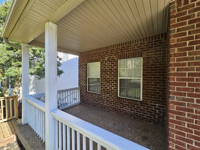 a view of a house with backyard and porch