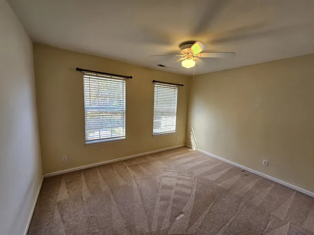a view of a livingroom with a chandelier fan