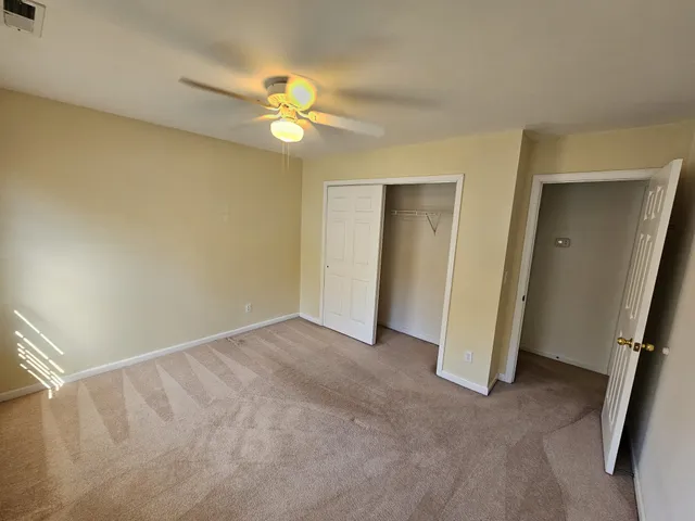 a view of a room with wooden floor and fan