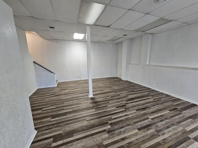 a view of a room with wooden floor