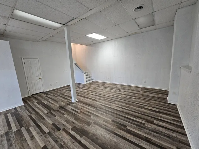 a balcony with wooden floor and fence