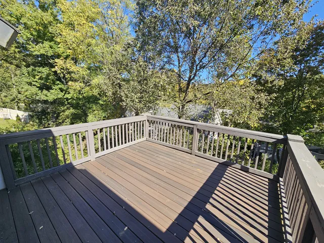 a view of a house with wooden deck