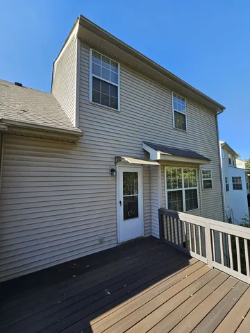 a view of a house with wooden deck