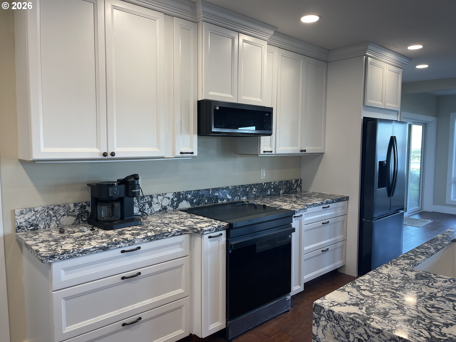 360 2nd Street Southeast Bandon, OR 97411 - Photo 11 of 28 a kitchen with stainless steel appliances granite countertop a stove and a granite counter tops