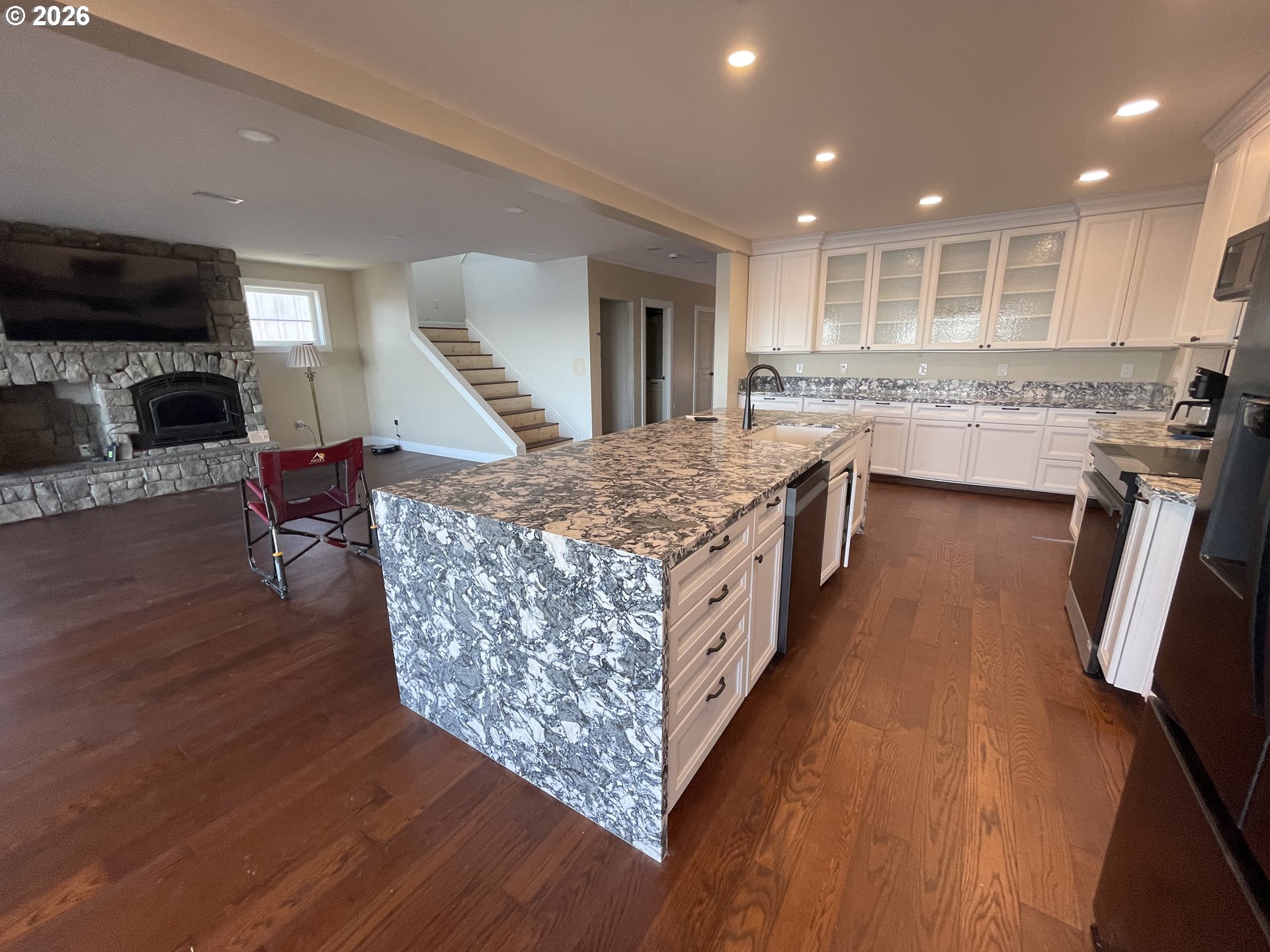 360 2nd Street Southeast Bandon, OR 97411 - Photo 13 of 28 a large kitchen with stainless steel appliances granite countertop a large counter top a stove and a wooden floors