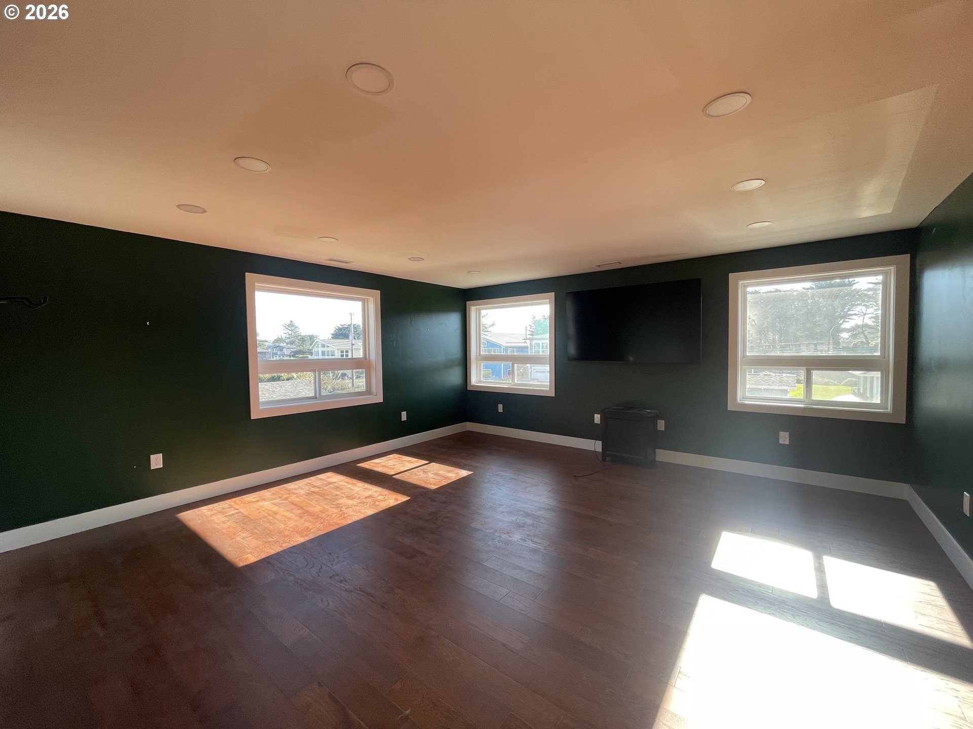 360 2nd Street Southeast Bandon, OR 97411 - Photo 23 of 28 a view of empty room with window and wooden floor