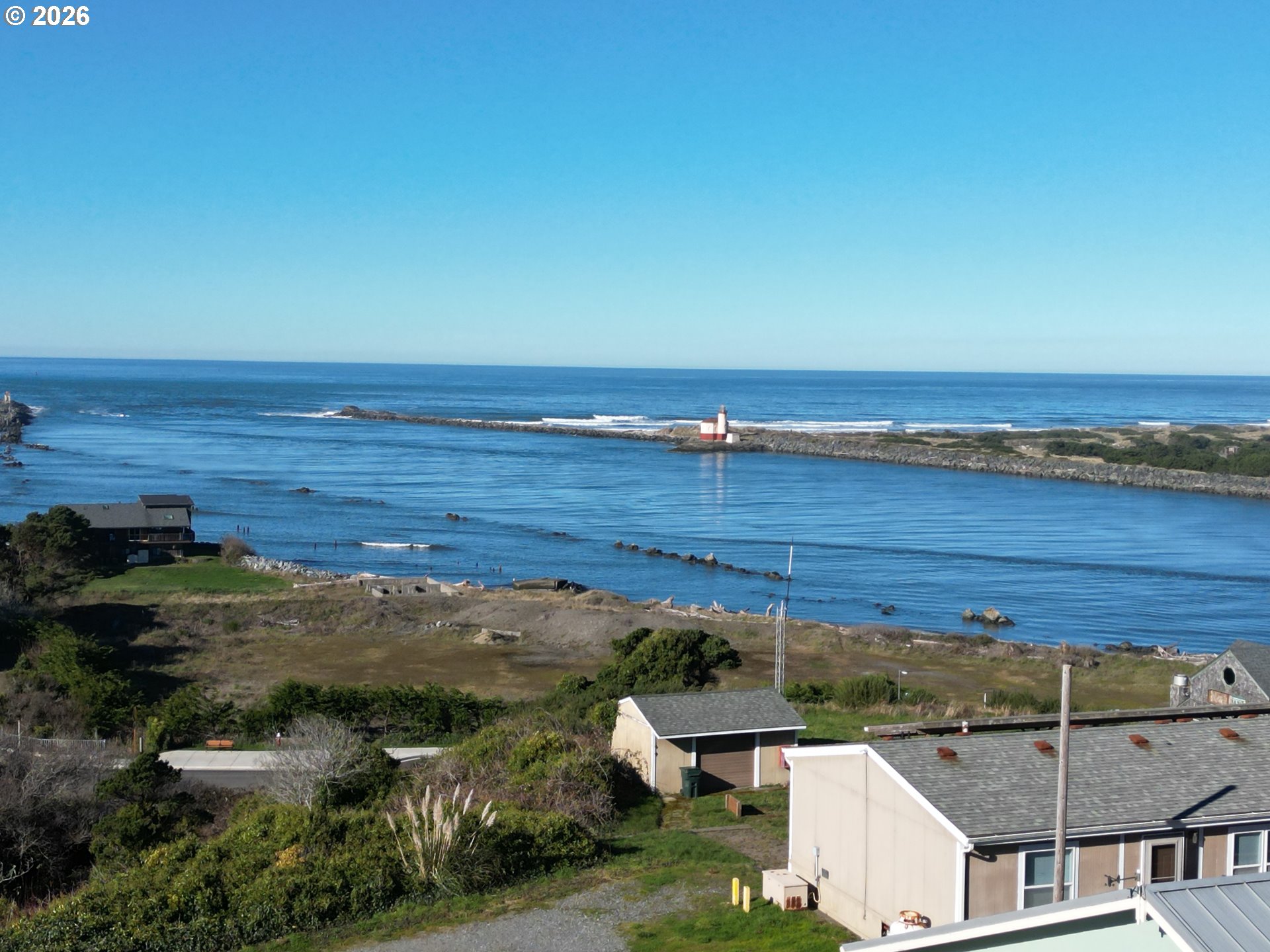 360 2nd Street Southeast Bandon, OR 97411 - Photo 7 of 28 an aerial view of a house with a lake view