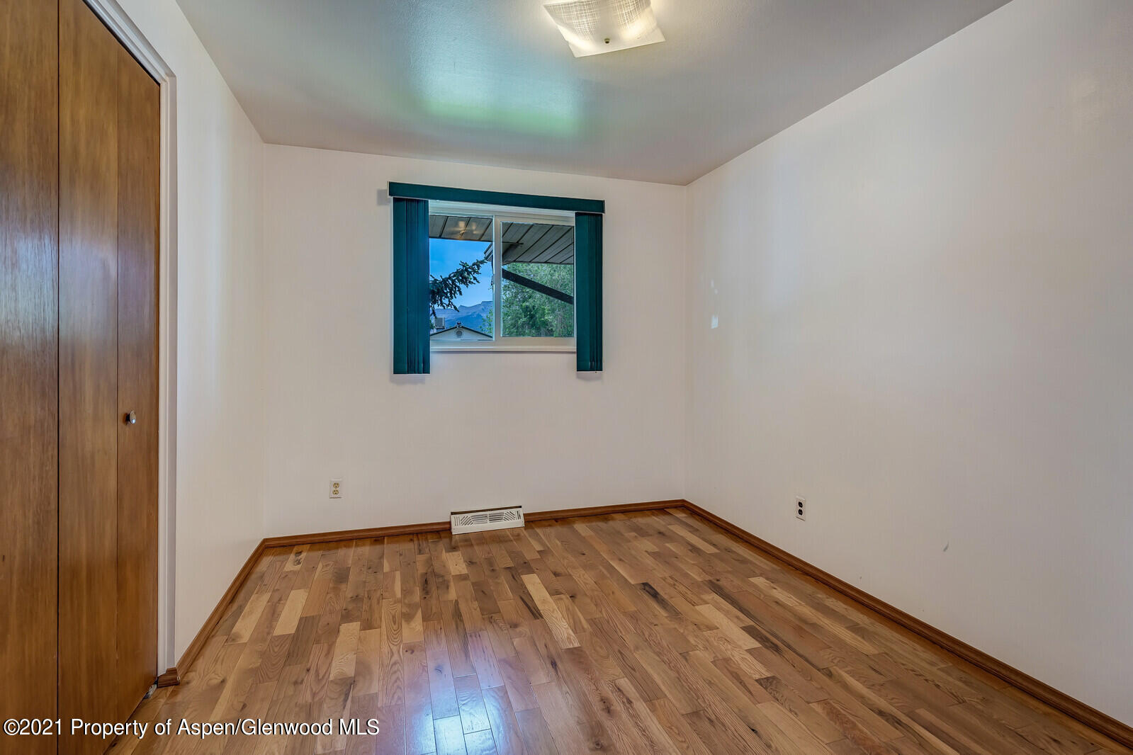 446 Elm Avenue Rifle, CO 81650 - Photo 13 of 28 a view of a room with wooden floor and window