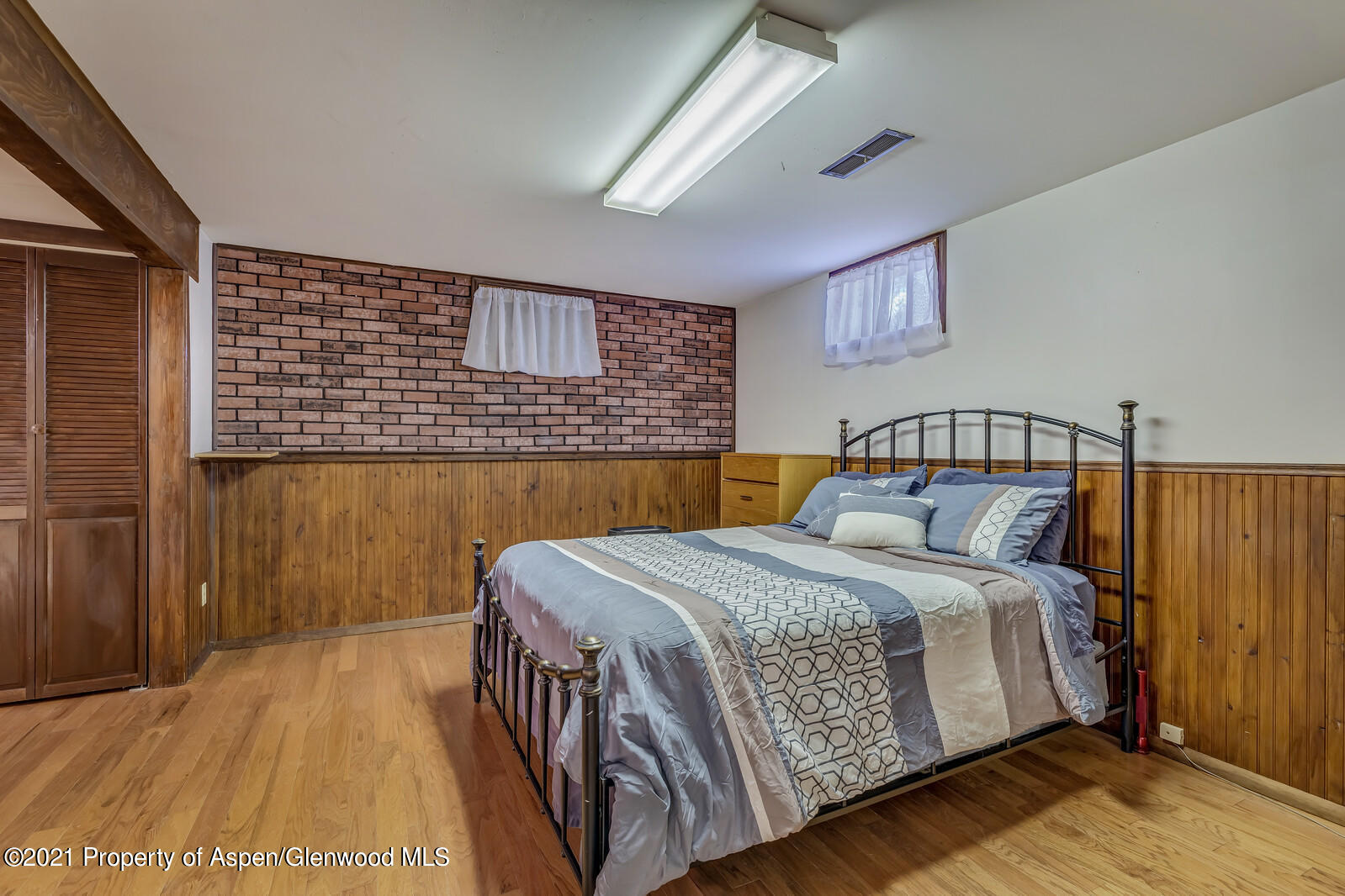 446 Elm Avenue Rifle, CO 81650 - Photo 16 of 28 a bedroom with a bed and wooden floor