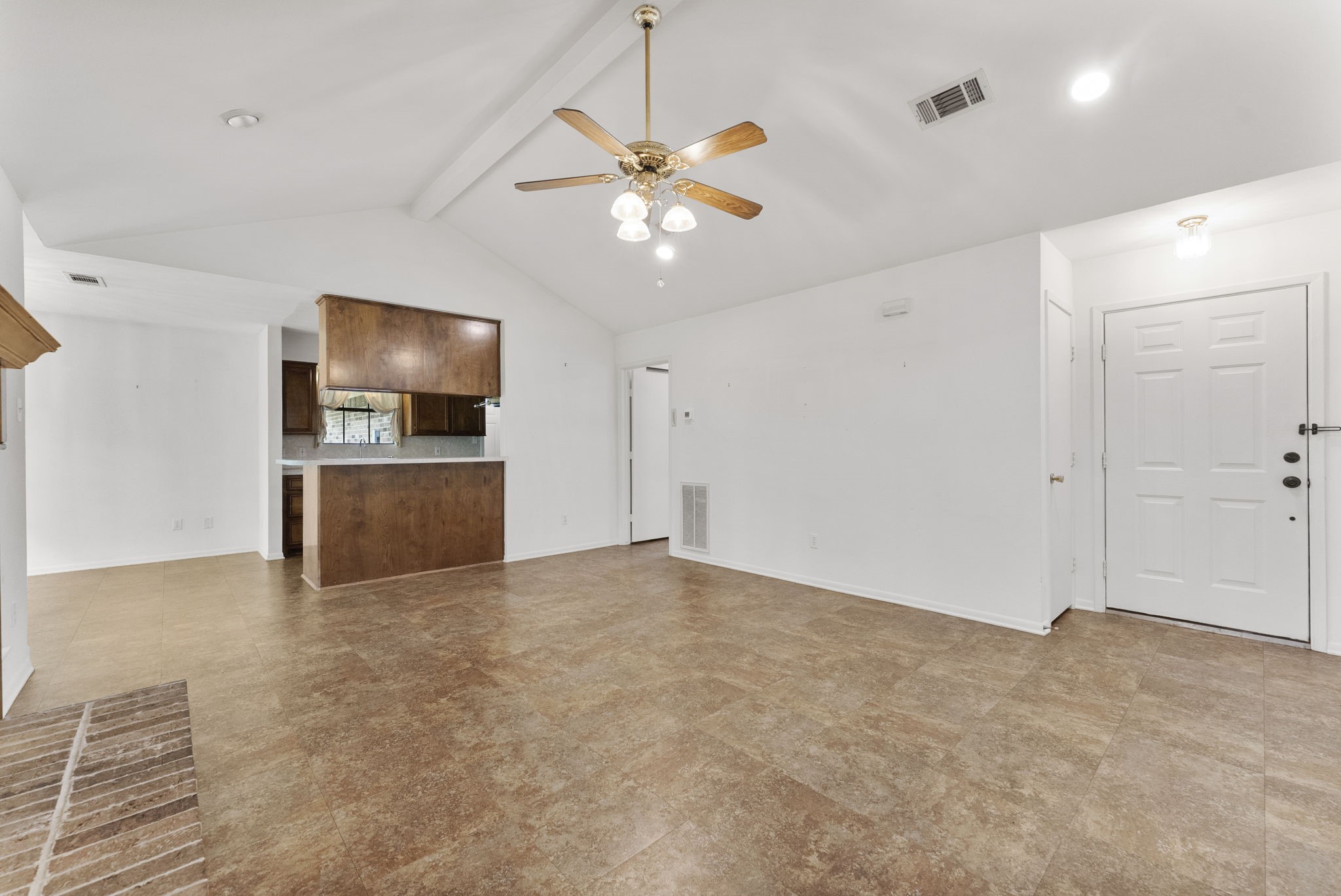 202 Sunset Boulevard Conroe, TX 77303 - Photo 10 of 50 This inviting space boasts an open layout with a seamless view into the kitchen, featuring warm wood cabinetry and a cozy ambiance perfect for family gatherings.