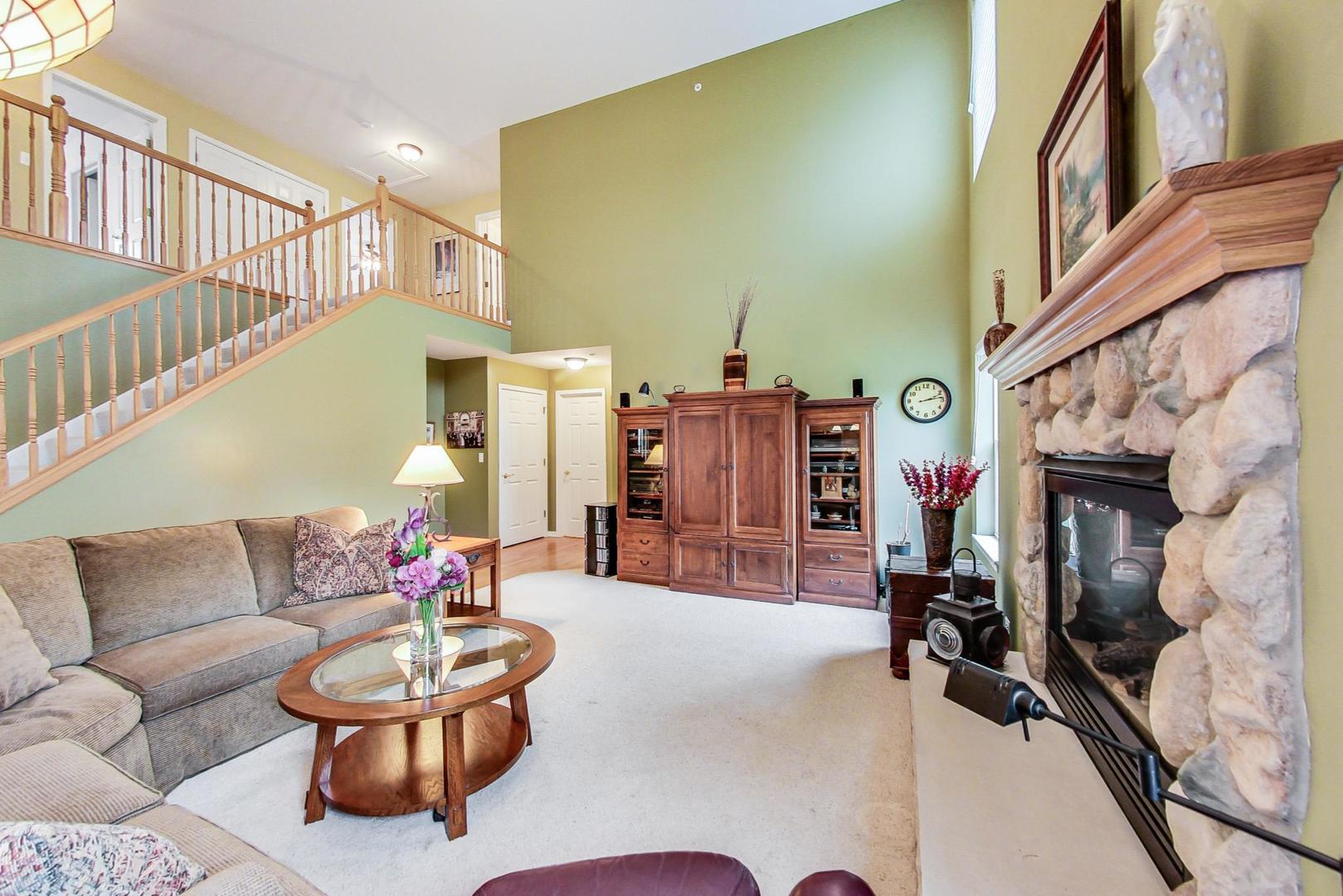 8052 Orchard Commons West Long Grove, IL 60060 - Photo 12 of 32 a living room with furniture and a fireplace
