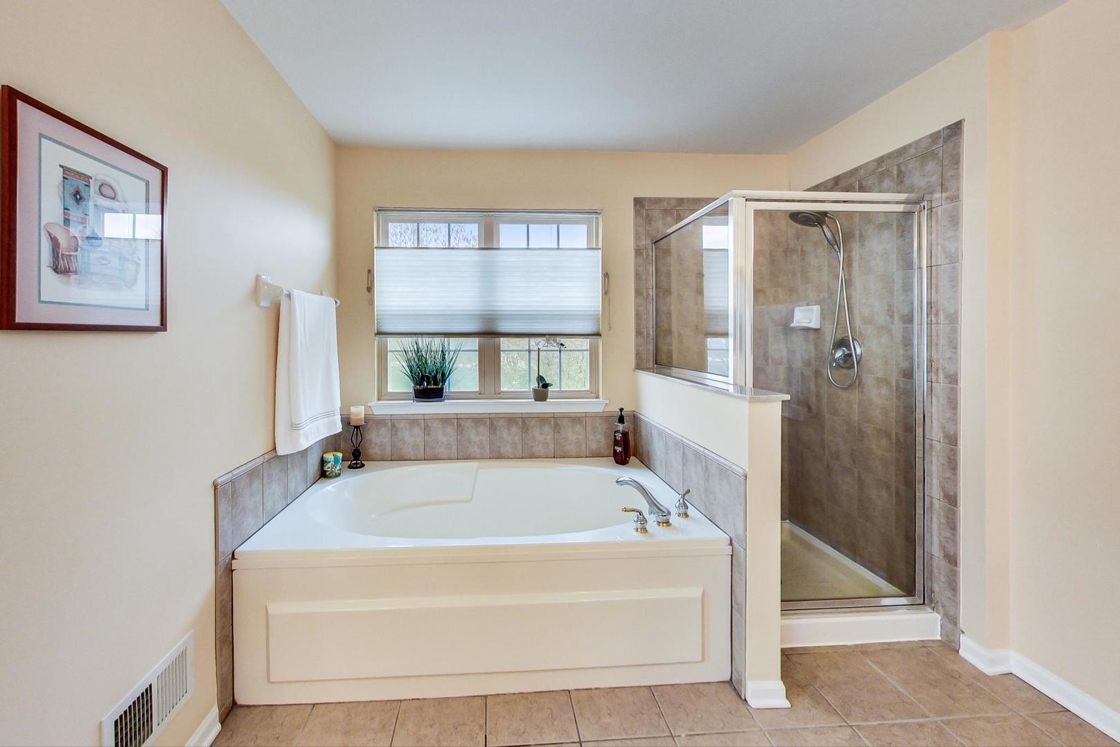 8052 Orchard Commons West Long Grove, IL 60060 - Photo 20 of 32 a bathroom with a tub and a shower