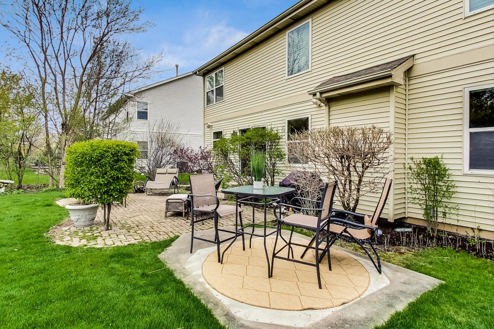 8052 Orchard Commons West Long Grove, IL 60060 - Photo 26 of 32 a view of a house with backyard sitting area and a garden